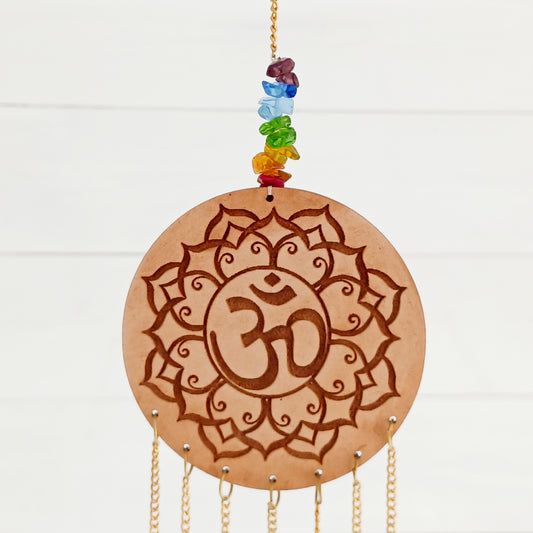 Enhance your space with spiritual harmony and vibrant energy using this beautifully crafted Wooden OHM Chakra Hanging Decoration. Featuring a finely engraved wooden OHM symbol and seven dangling OHM charms, each representing one of the seven chakra colors, this unique piece blends powerful symbolism with elegant design.