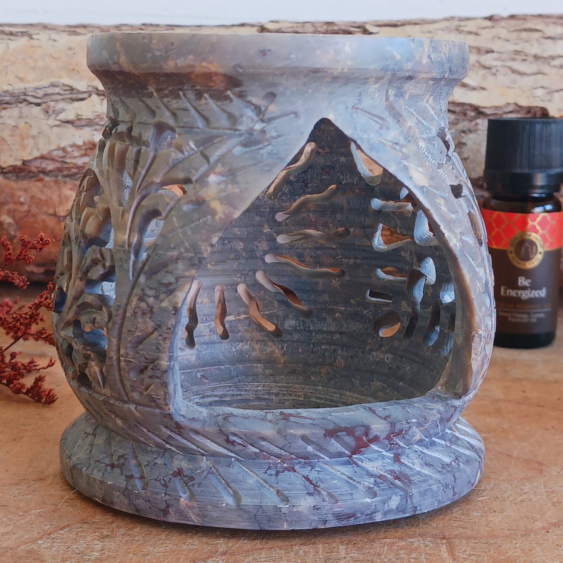 Enhance your home with calming fragrance and natural style with this beautifully carved soapstone oil burner. Featuring an elegant central sun motif with detailed leaf designs, this decorative aromatherapy burner adds warmth, ambience, and relaxing scent to any room.