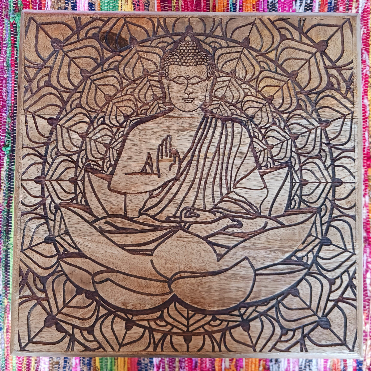 Bring peace and tranquillity to your home with this beautiful handcrafted mango wood table, featuring an intricately carved Buddha and Lotus Flower design on the tabletop. Combining traditional craftsmanship with spiritual symbolism, this unique wooden table makes a wonderful addition to a meditation space, Buddhist altar, yoga room or peaceful home sanctuary.