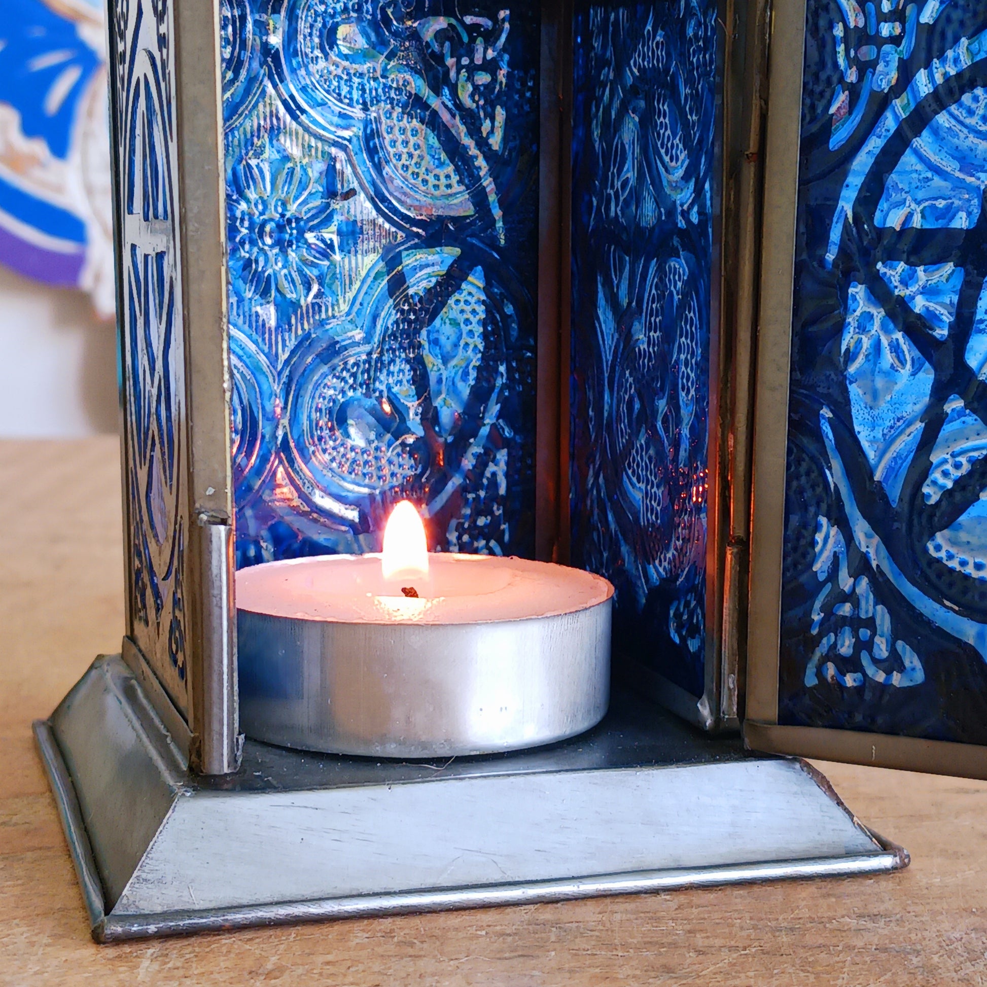 Bring warmth, colour and spiritual harmony to your home with this beautiful Pentagram Glass Lantern. Designed with vibrant coloured glass panels and a decorative metal cut-out canopy, this lantern creates a calming glow that enhances meditation spaces, yoga rooms and home décor.