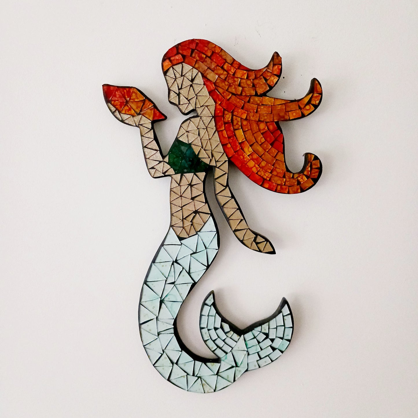 Transform your space with this beautiful Mosaic Mermaid Wall Decor, designed to inspire wonder and enchantment. Featuring intricate mosaic detailing, this magical mermaid captures light beautifully, adding texture, depth, and visual interest to any room.