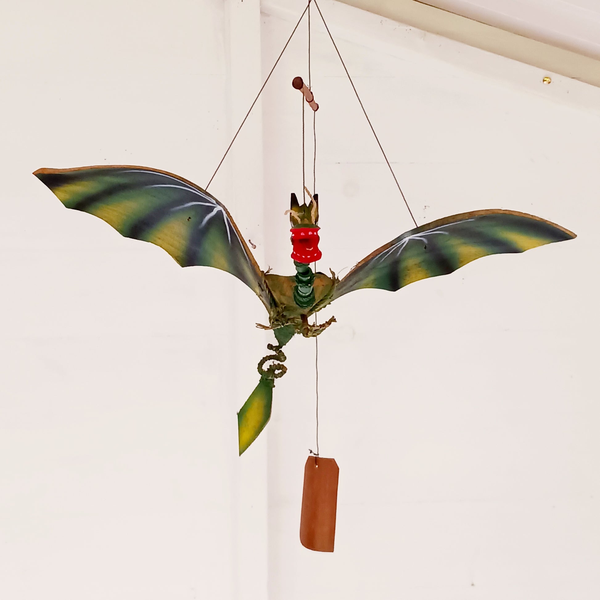 Bring a touch of magic and movement to your home or garden with this Large Green Coconut Dragon Mobile, a beautifully handcrafted decorative piece handmade in Indonesia.