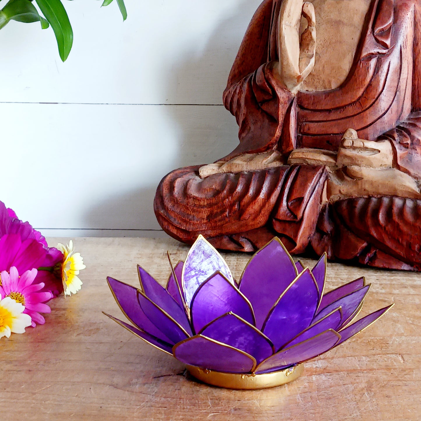 Illuminate your space with the peaceful elegance of our Capiz Shell Lotus Flower Candle Holder. Symbolizing enlightenment and serenity, this stunning handcrafted piece features delicate purple petals edged in gold, forming the iconic lotus shape. When lit, the layered design diffuses candlelight into a soft, radiant glow — ideal for creating a calming ambiance indoors or outdoors.