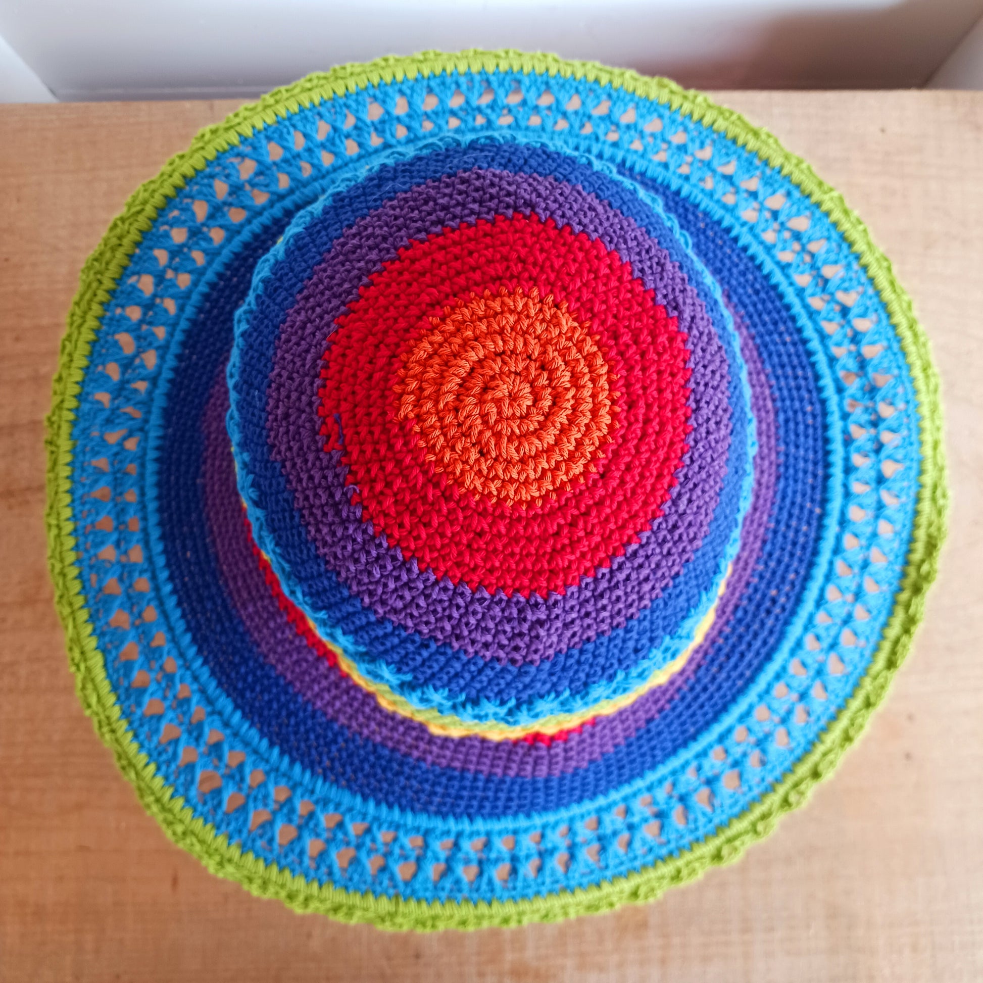 Handmade rainbow crochet sun hat with a flexible brim. Perfect for holidays, beach days & festivals. Unique, lightweight, and ready for sunny adventures!