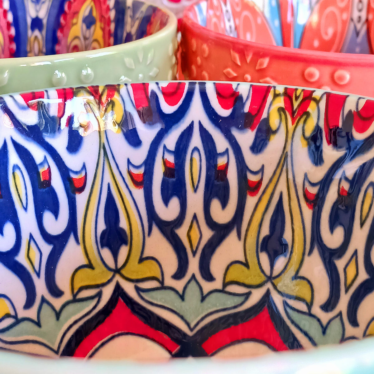 Bring the warmth and colour of the Mediterranean into your home with this beautiful Tuscany-inspired ceramic mug. Featuring a vibrant glazed exterior and an eye-catching embossed geometric pattern inside, this stylish mug is inspired by the rustic terracotta tiles and intricate murals found in sun-soaked Italian villages.