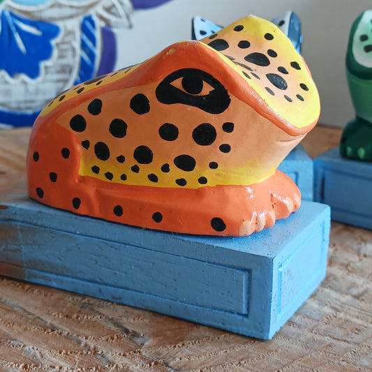Bring charm and character into your home with this decorative wooden door stopper, featuring a turquoise base and a playful, hand-painted dotty frog design in vibrant blue, green, and orange. Perfect for propping open doors in style, this quirky wedge door stop is both practical and fun.