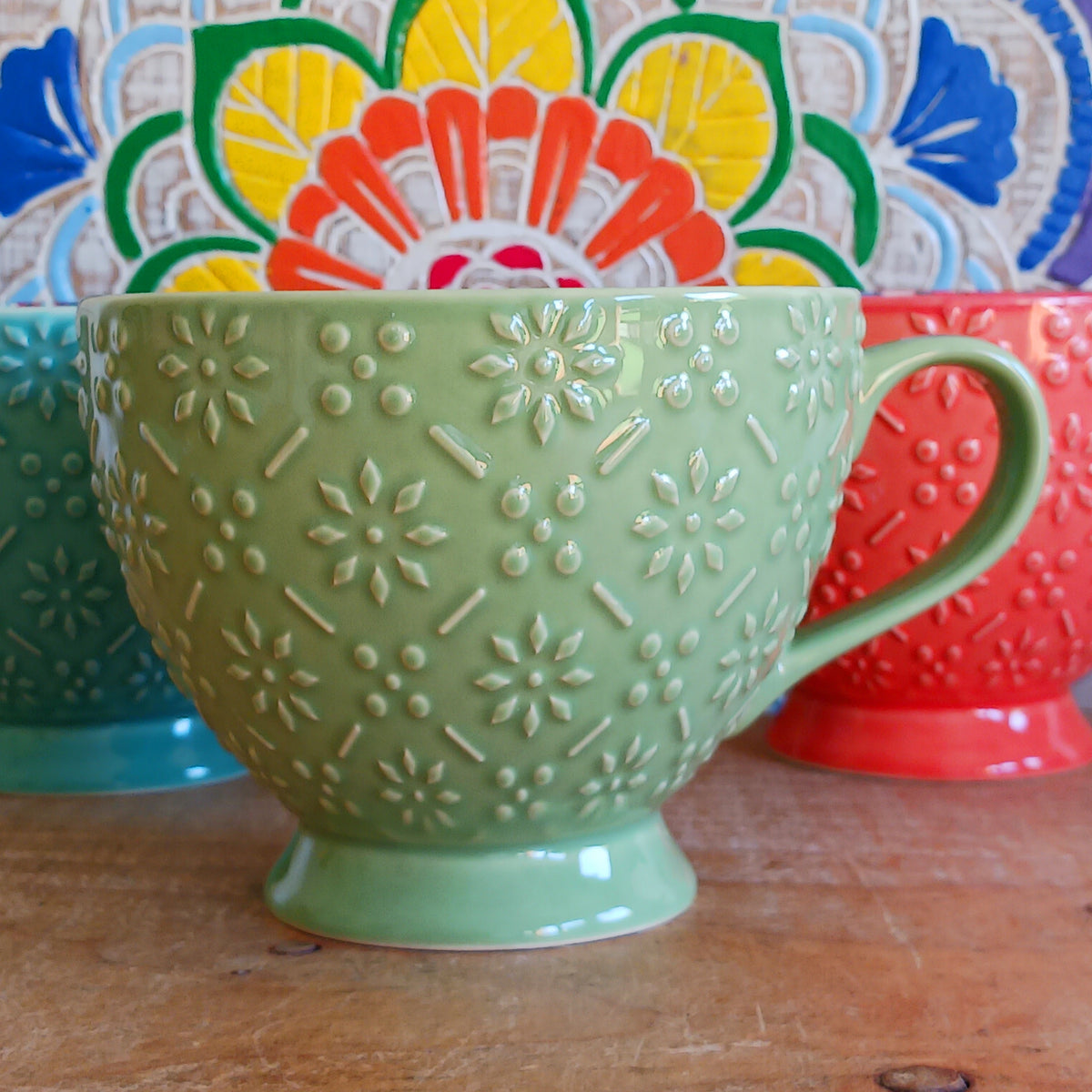 Bring the warmth and colour of the Mediterranean into your home with this beautiful Tuscany-inspired ceramic mug. Featuring a vibrant glazed exterior and an eye-catching embossed geometric pattern inside, this stylish mug is inspired by the rustic terracotta tiles and intricate murals found in sun-soaked Italian villages.