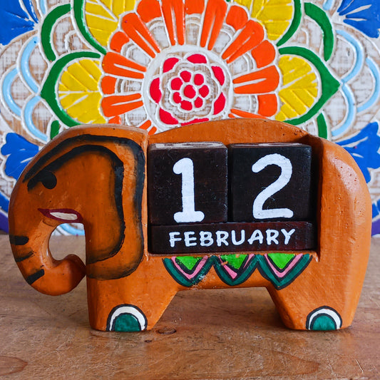 Brighten up your desk with this charming hand-painted wooden elephant calendar! This cheerful desk-buddy is both practical and eco-friendly, making it a perfect addition to your work or study space. Simply rotate the wooden blocks each day to keep track of the date – no need to replace it year after year. A thoughtful, sustainable gift for elephant lovers, students, or anyone who enjoys unique handcrafted décor.