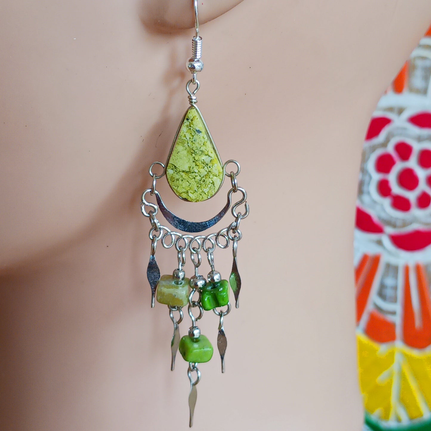 Add a touch of bohemian beauty to your look with these handmade Peruvian stone earrings. Featuring green aventurine stones and finished with silver-plated hooks, each pair is carefully crafted in small workshops in Peru.
