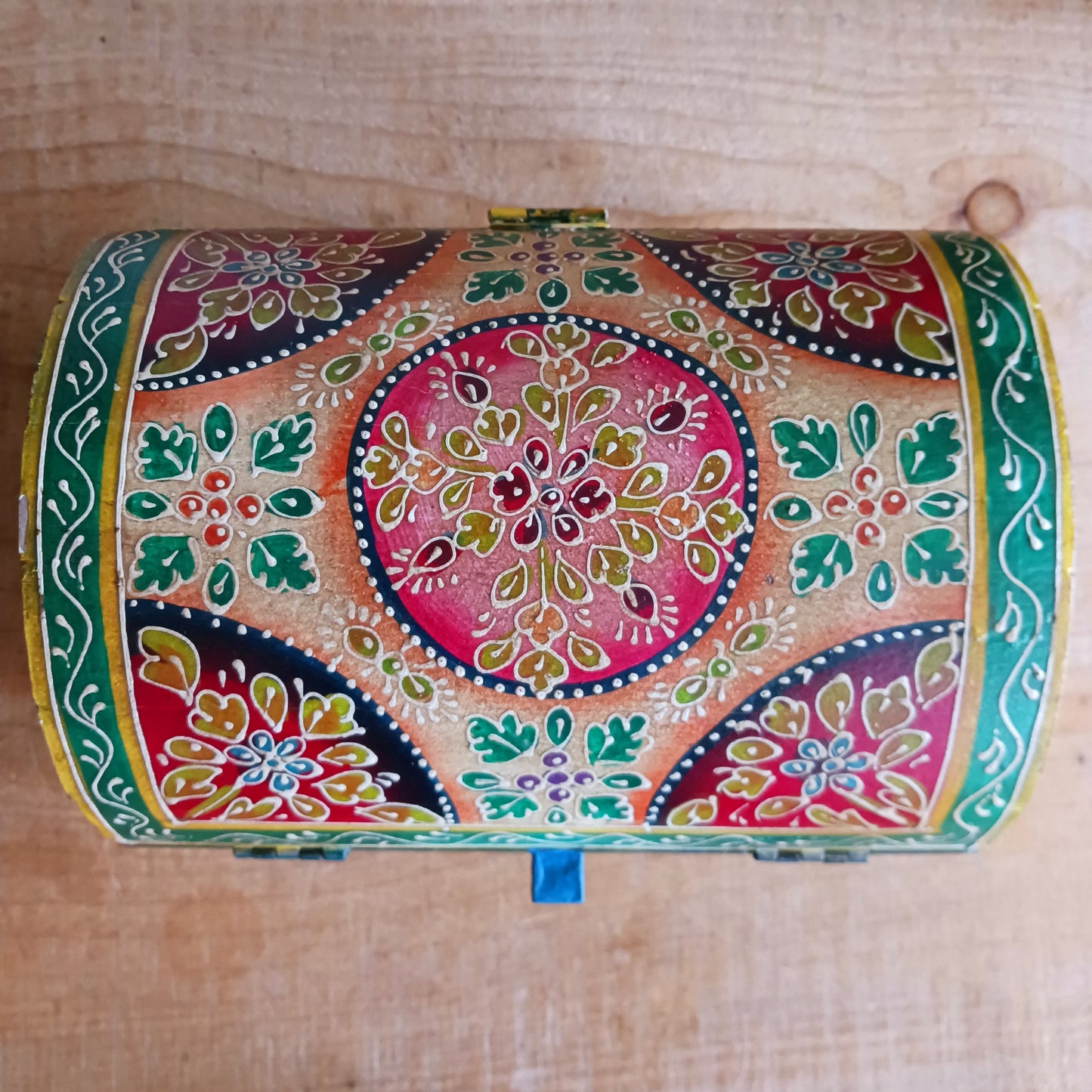 Add a vibrant touch to your home décor with this beautiful handmade domed wooden box, expertly crafted and hand painted in a striking lime and pink floral pattern. Featuring a hinged domed lid and secure front closure, this decorative storage box combines traditional craftsmanship with eye-catching design.