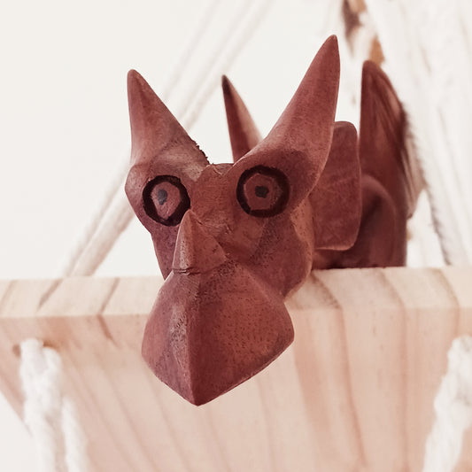 Bring personality and charm into your home with this beautiful hand-carved Shelf Dragon. Expertly crafted with intricate details, this whimsical dragon is designed to perch perfectly on any shelf, mantle, or display space. Its expressive features, artisan carving, and warm natural wood finish make it a captivating accent piece for fantasy lovers, collectors, and anyone who appreciates unique décor.