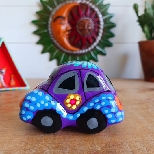 This fun little VW car ornament oozes retro vibes. With it's bold flower power design and vibrant colours it will brighten up any sideboard. This type of car, affectionately known as a 'bochito', are very popular in Mexico due to their reliability when driving about steep roads. Incidentally, the Mexican town of Puebla was home to the last Beetle production factory which only closed in 2003.