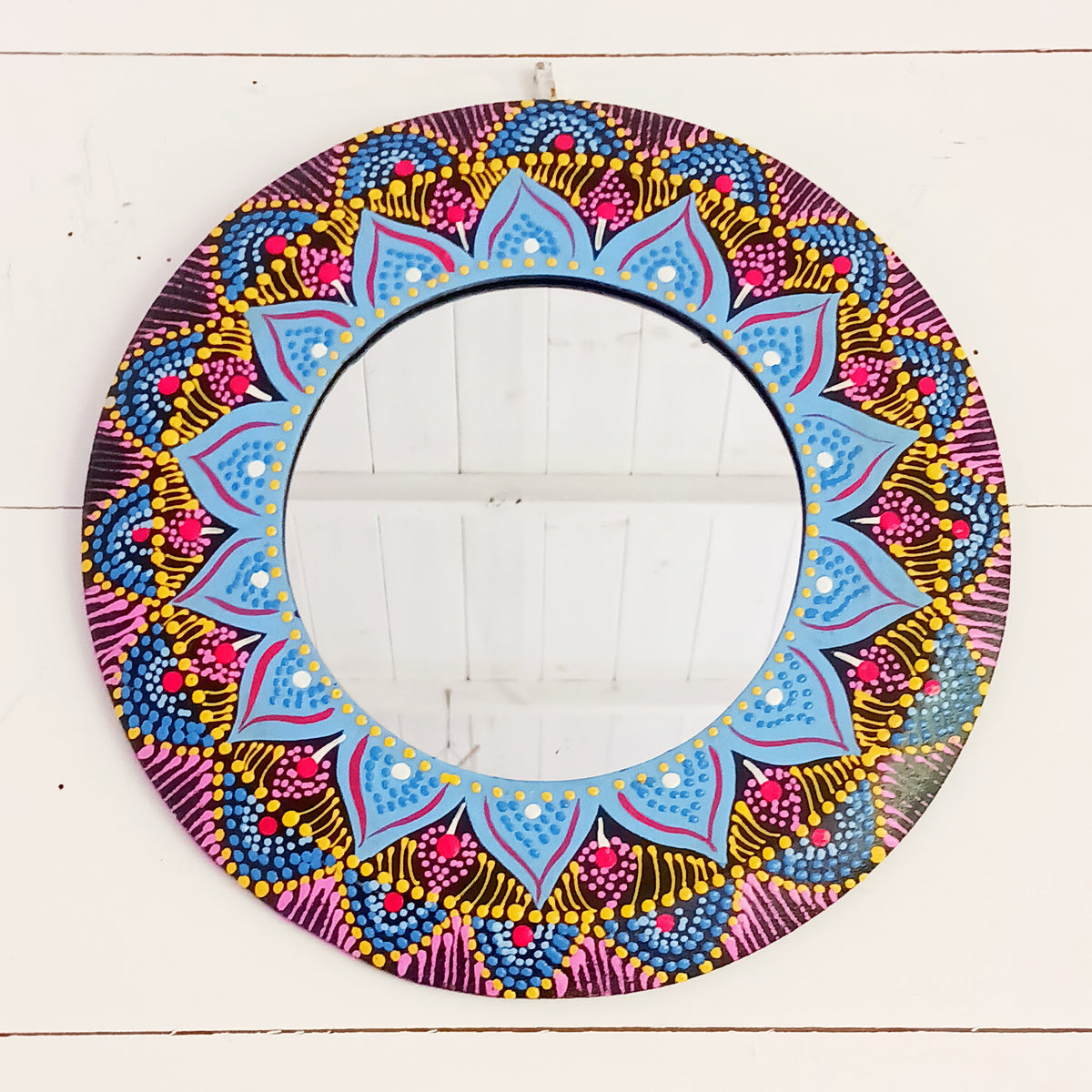 Add a splash of colour and bohemian charm to your home with this beautiful Dot Painted Mirror, handcrafted in Bali by skilled artisans. Featuring a wooden frame decorated with intricate dot painting, its vibrant colours and mandala-inspired patterns create a striking decorative piece that combines everyday practicality with artistic style.