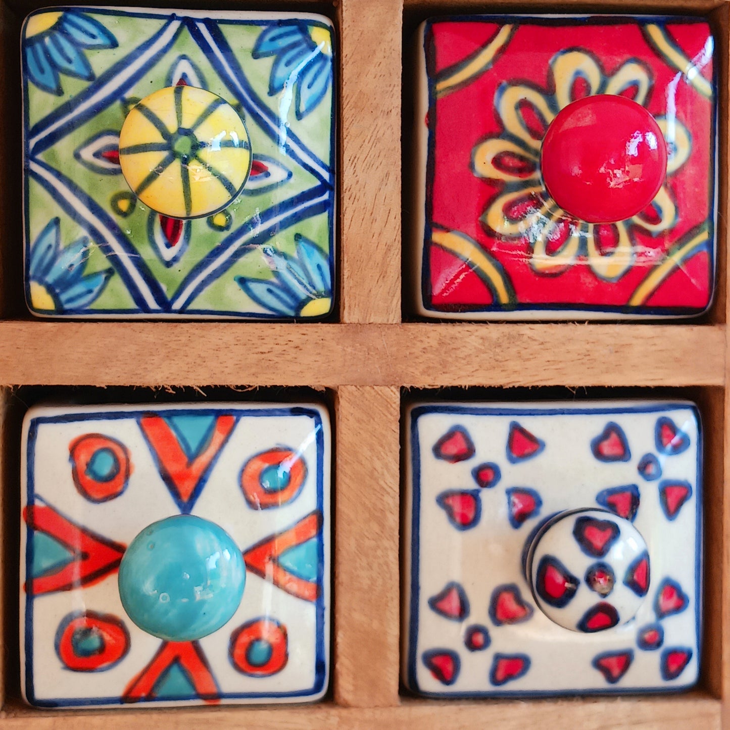 Add a touch of authentic Indian craftsmanship to your home with this Handcrafted Indian Ceramic 16-Drawer Mini Chest. Featuring 16 individually hand-painted ceramic drawers set within a warm wooden frame, this decorative storage cabinet is both practical and beautifully unique.