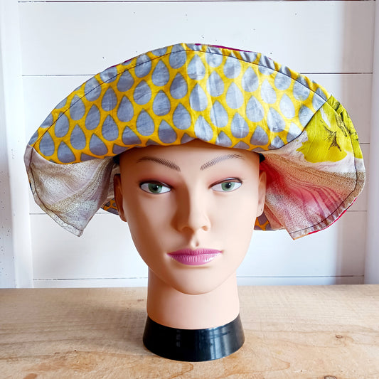 This colourful sunhat is made from patches of remnants from saris. Each hat is unique and features a wide brim to keep the sun from your face and keep you cool, lined with plain cotton to keep you even cooler. These hats are lightweight so easy to carry around in your bag. Ideal for travelling and festivals.