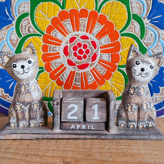Add charm and functionality to your space with our Wooden Cats Calendar. Featuring two adorable cats perched on a timeless wooden block design, this perpetual calendar is the perfect mix of décor and practicality. Whether on your desk, shelf, or office table, it helps you stay organized while adding a playful, heart warming touch to your day. A wonderful gift for cat lovers and anyone who enjoys unique home or office accessories.