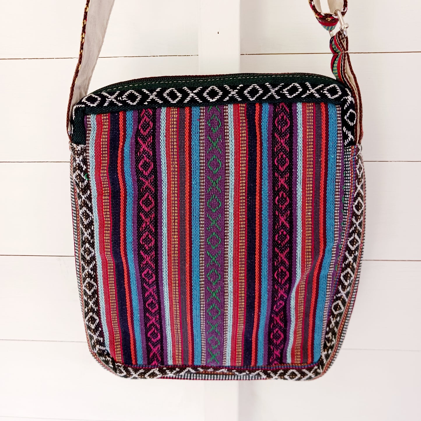 This is such a fantastic and handy messenger bag or satchel. Made from hemp with cotton lining, this bag is beautifully crafted featuring lots of handy compartments. On the front are three colourful and embroidered mushrooms.
