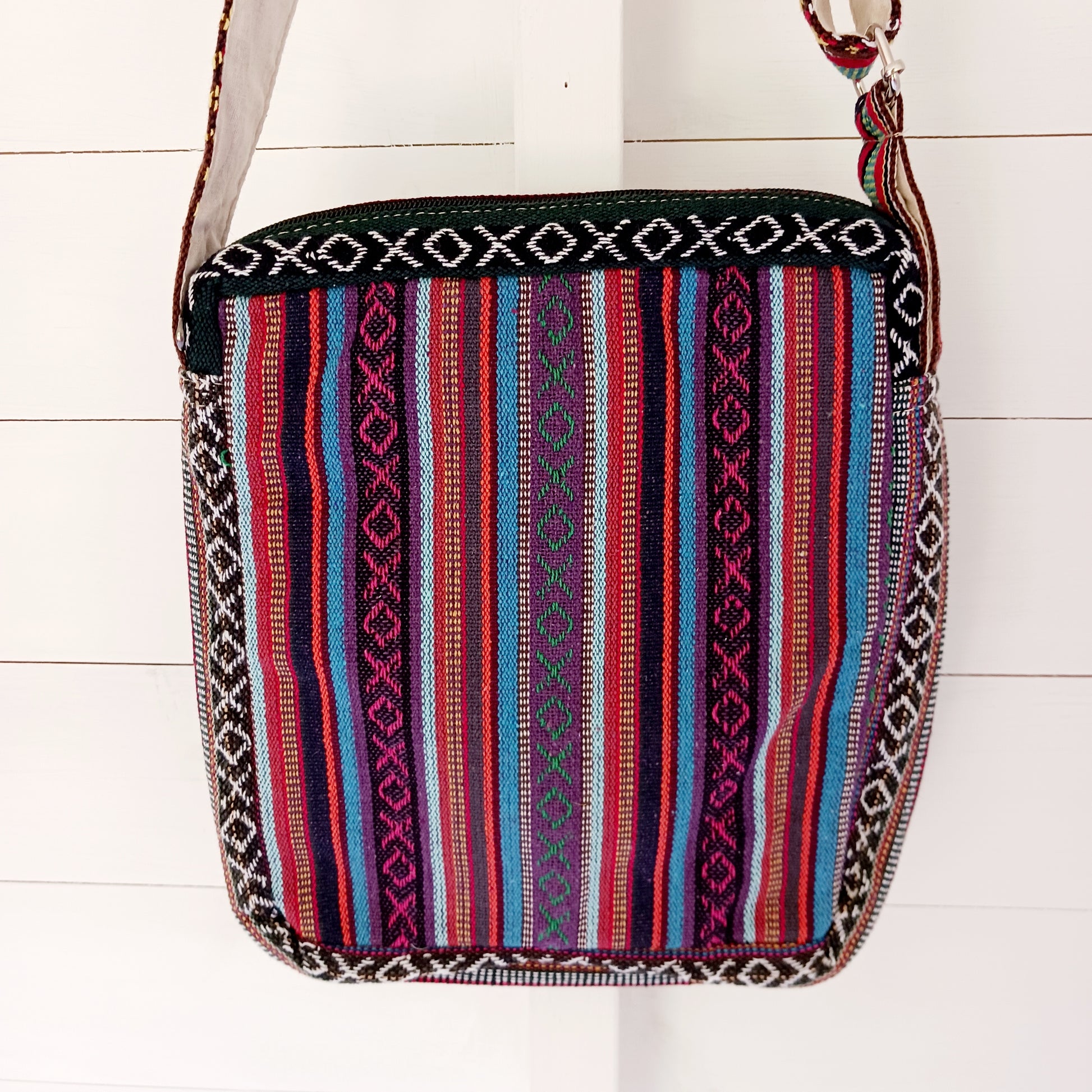 This is such a fantastic and handy messenger bag or satchel. Made from hemp with cotton lining, this bag is beautifully crafted featuring lots of handy compartments. On the front are three colourful and embroidered mushrooms.