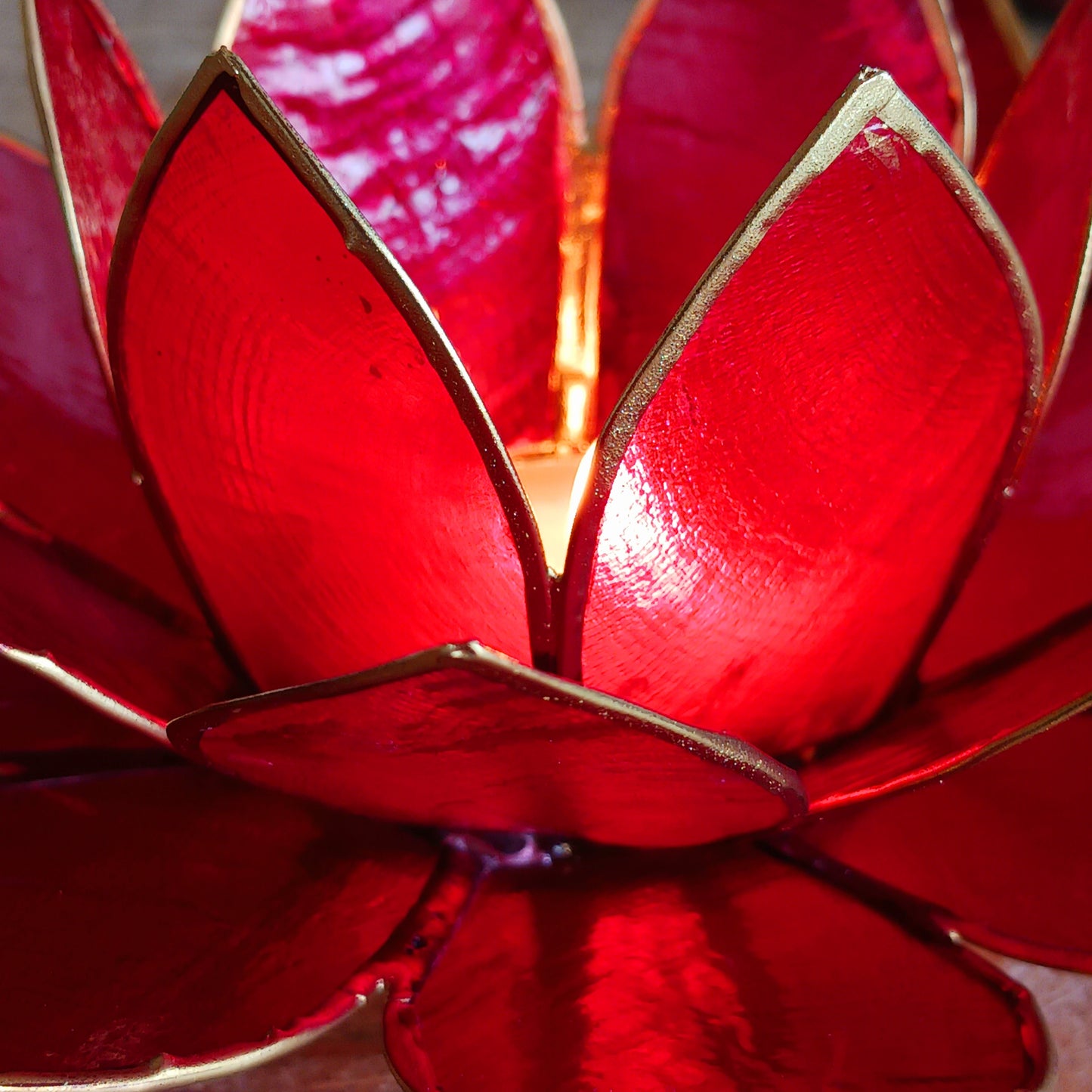 Illuminate your space with the peaceful elegance of our Capiz Shell Lotus Flower Candle Holder. Symbolizing enlightenment and serenity, this stunning handcrafted piece features delicate red petals edged in gold, forming the iconic lotus shape. 