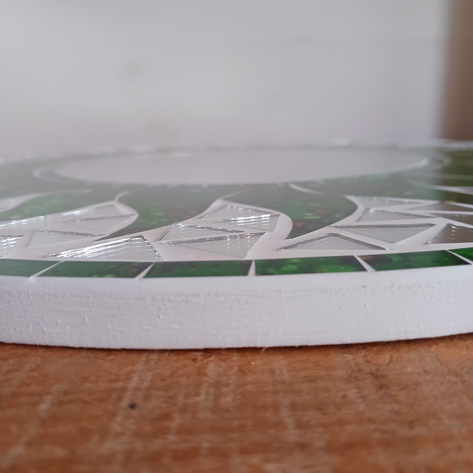 Add warmth, energy, and artistic charm to your home with this beautiful Vibrant Green Mosaic Sun Mirror. Designed with dazzling green mosaic tiles arranged in a radiant sunburst pattern, this captivating wall accent instantly brightens any room.