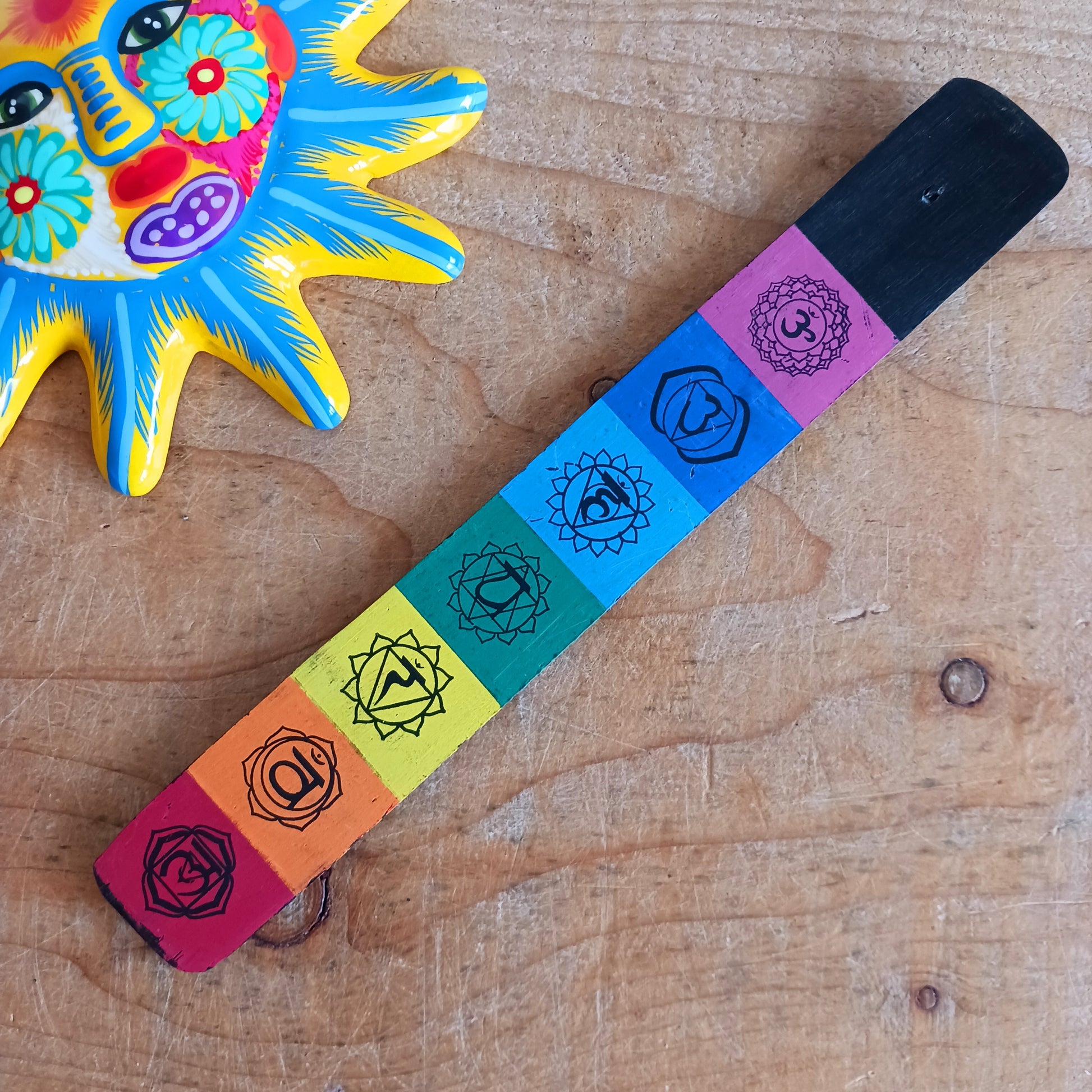 This simple and functional incense holder is designed to elevate any space. It is made from sustainable mango wood and features a stunning chakra-inspired design. 