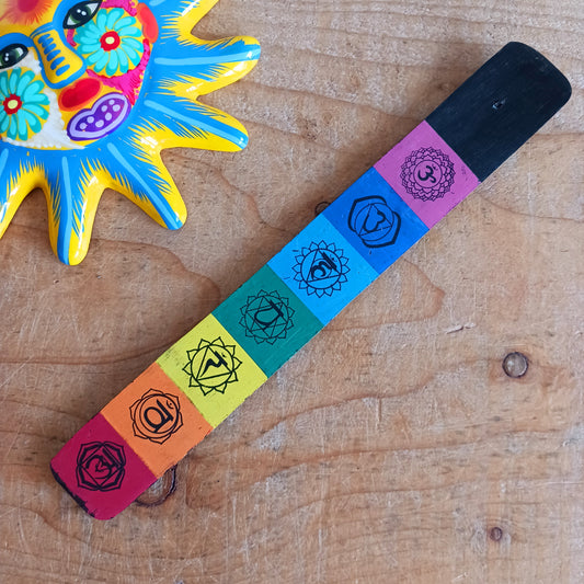 This simple and functional incense holder is designed to elevate any space. It is made from sustainable mango wood and features a stunning chakra-inspired design. 