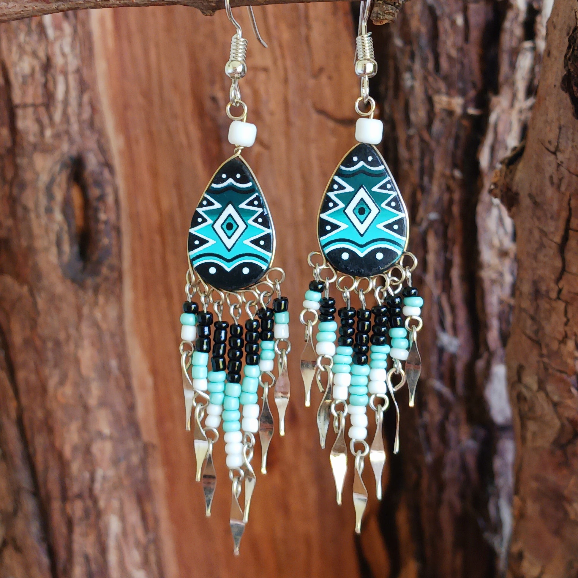 These beautiful and eye-catching earrings are handmade in Peru and feature traditional Incan patterns on the front, the back is coloured black. They are shaped in a teardrop style and are finished with coloured coordinating beads, silver embellishments and silver-plated hooks. Ideal for a night out, for dressing up your Boho look or as a gift for family or friends.