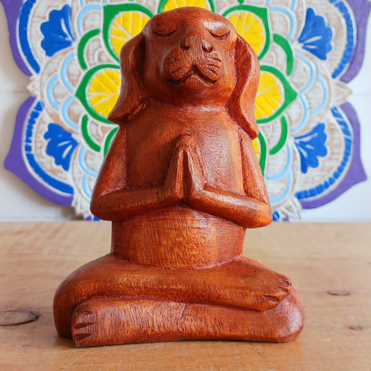Add a touch of playful serenity to your space with this Meditating Dog Woodcarving. With its paws pressed together in prayer and eyes gently closed, this charming figure radiates calm and quiet joy. Perfect for yoga studios, meditation corners, or any space that could use a little extra soul, it brings a relaxed, earthy energy into your home.