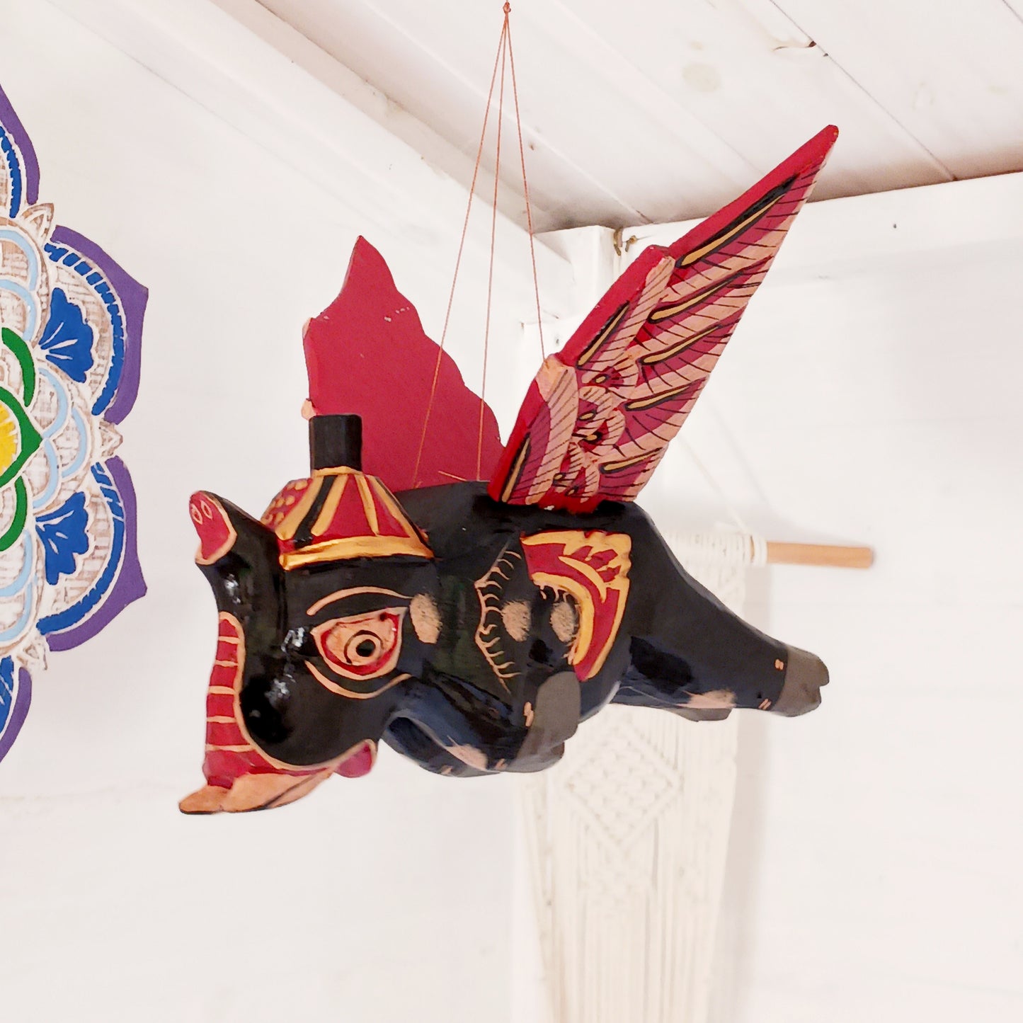 Bring a touch of wonder to your space with this enchanting Flying Elephant Mobile. Each piece is hand-carved from lightweight wood and finished with unique hand-painted patterns, giving every elephant its own personality. Delicately balanced wings hover gracefully with the slightest breeze, creating a calming sense of motion and magic.