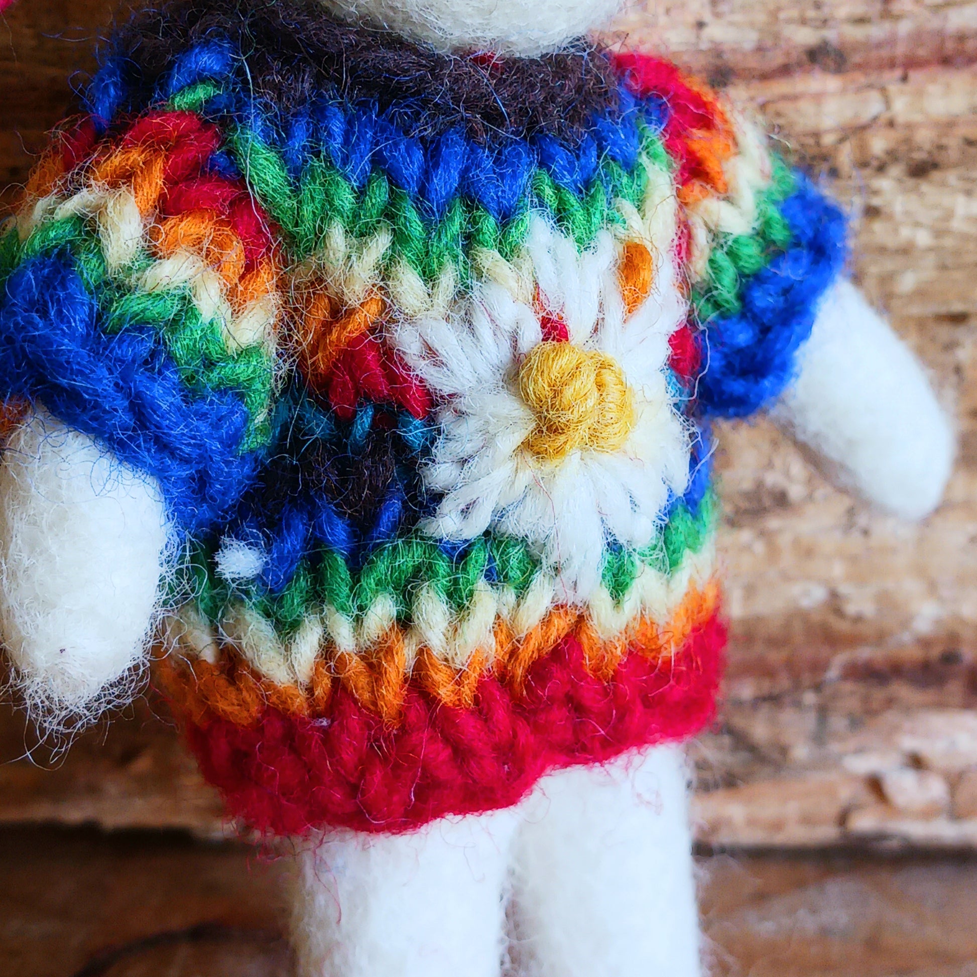 Bring instant festive cheer to your home with this adorable Christmas Tree Mouse Decoration. Dressed in a hand-knitted rainbow jumper and matching hat, this charming little mouse captures the magic of the season at first sight. Its sweet pink nose, expressive eyes, and cartoon-like ears bring out the childlike joy in anyone who sees it.