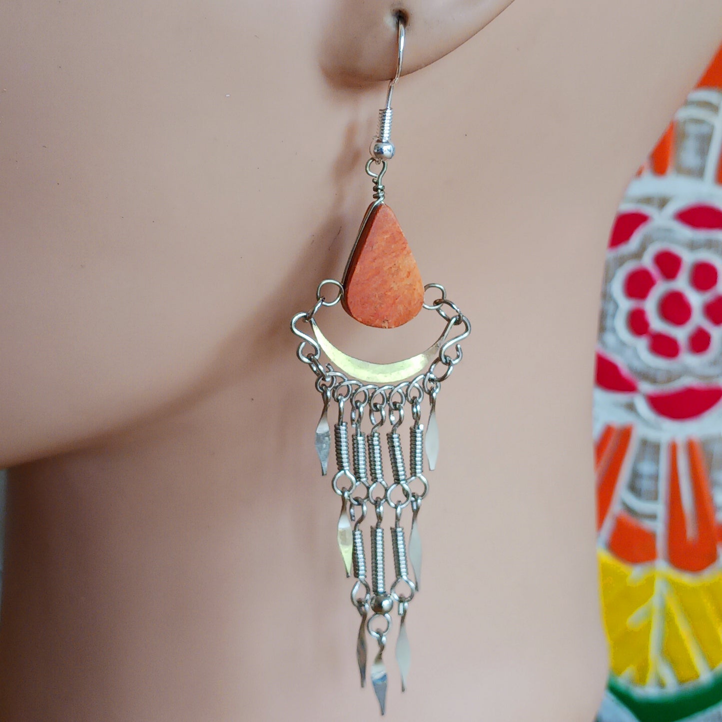 Add a touch of bohemian beauty to your look with these handmade Peruvian stone earrings. Featuring orange stones and finished with silver-plated hooks, each pair is carefully crafted in small workshops in Peru.