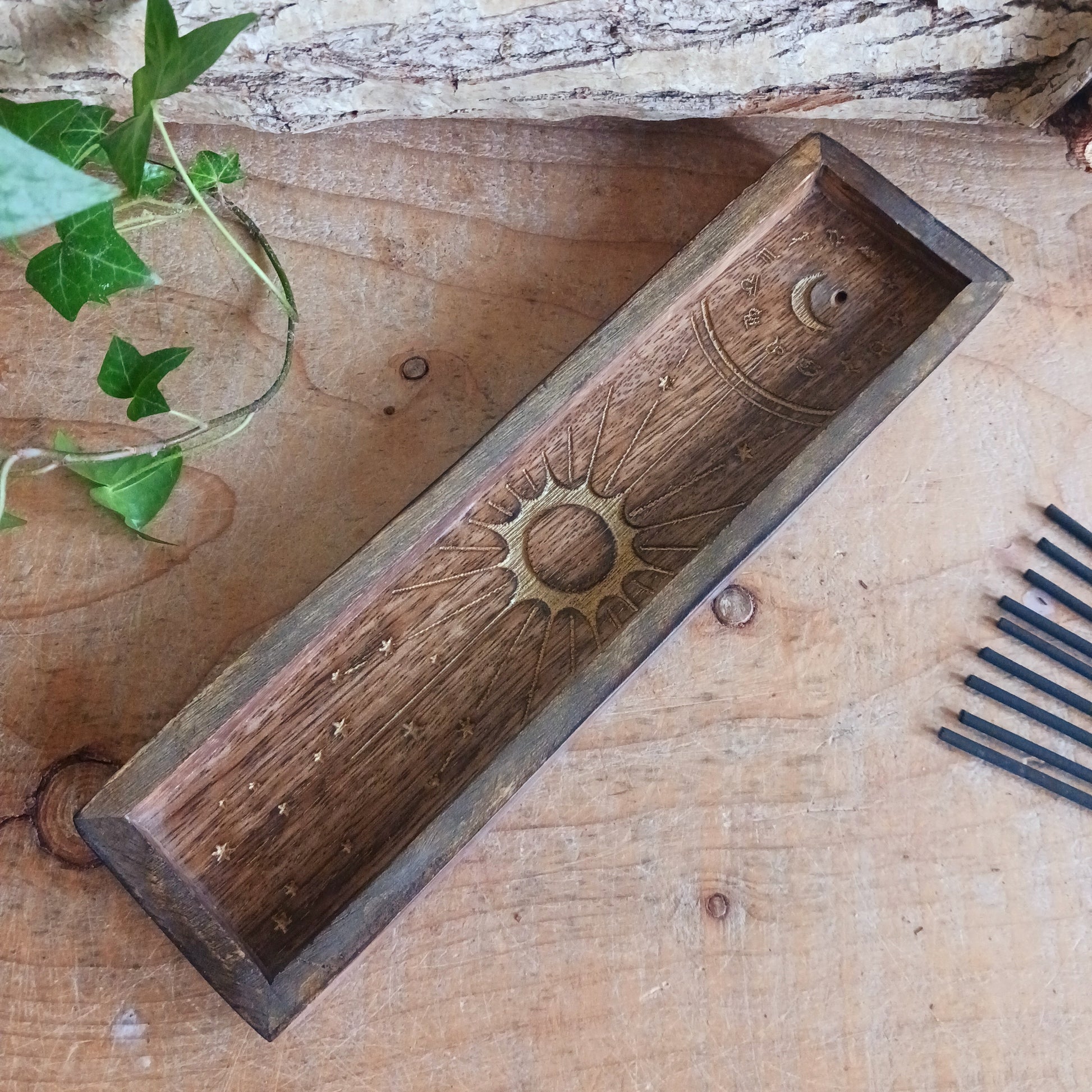This Zodiac Incense Holder and Crystal Tray is a beautifully crafted ritual accessory made from natural mango wood and finished with gold-stamped astrological symbolism. Designed to hold incense sticks while offering a dedicated tray space for crystals or ritual objects, it brings structure and intention to daily practice.