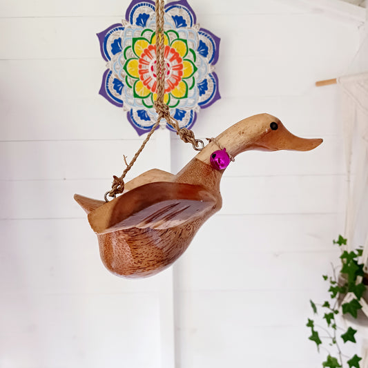 Bring a touch of whimsy and natural beauty to your home with this Handcarved Wooden Flying Duck. Each piece is meticulously crafted from solid wood, showcasing the artisan’s skill and attention to detail. The duck’s natural finish highlights the unique wood grain, adding a rustic charm that complements any interior style.