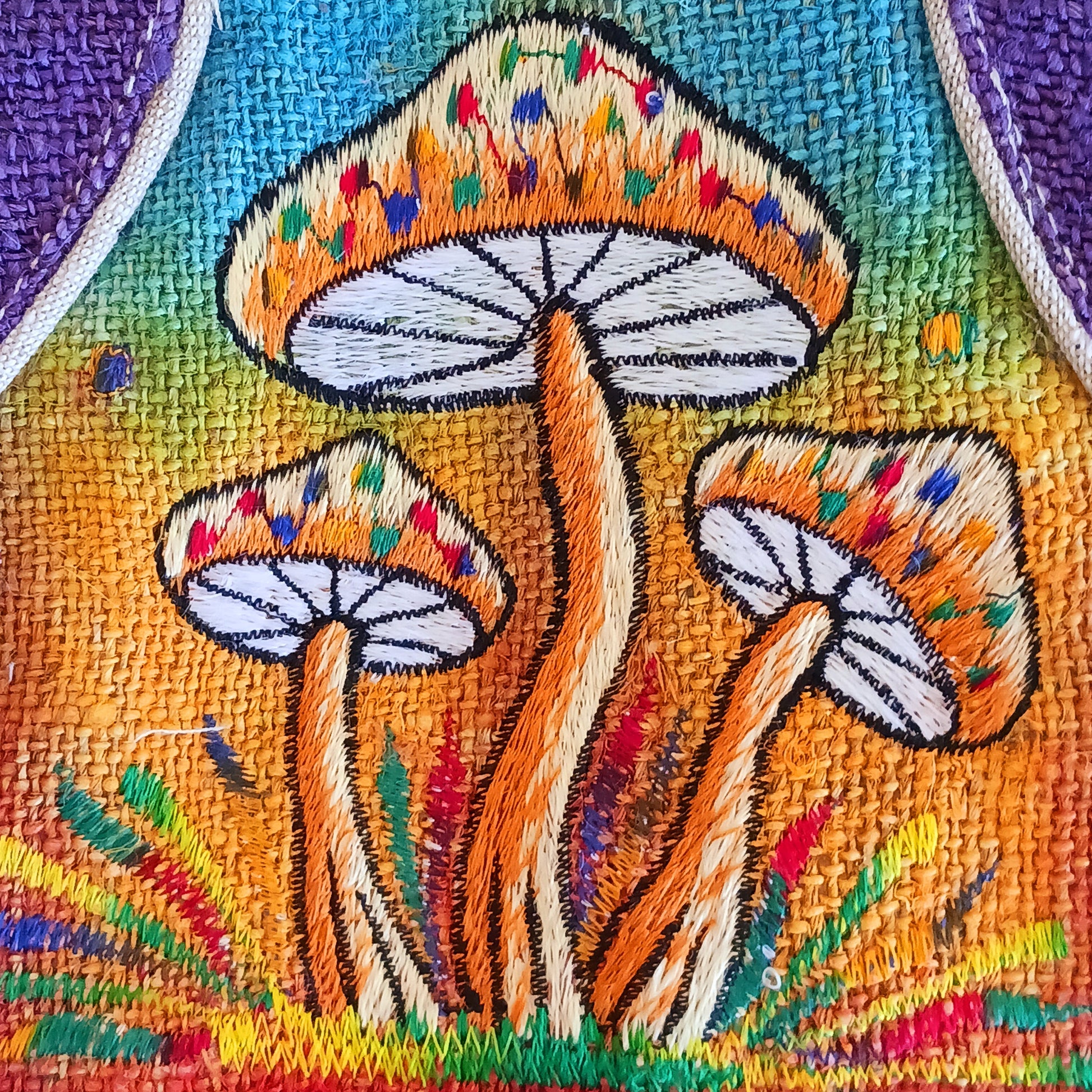 This is such a fantastic and handy messenger bag or satchel. Made from hemp with cotton lining, this bag is beautifully crafted featuring lots of handy compartments. On the front are three colourful and embroidered mushrooms.