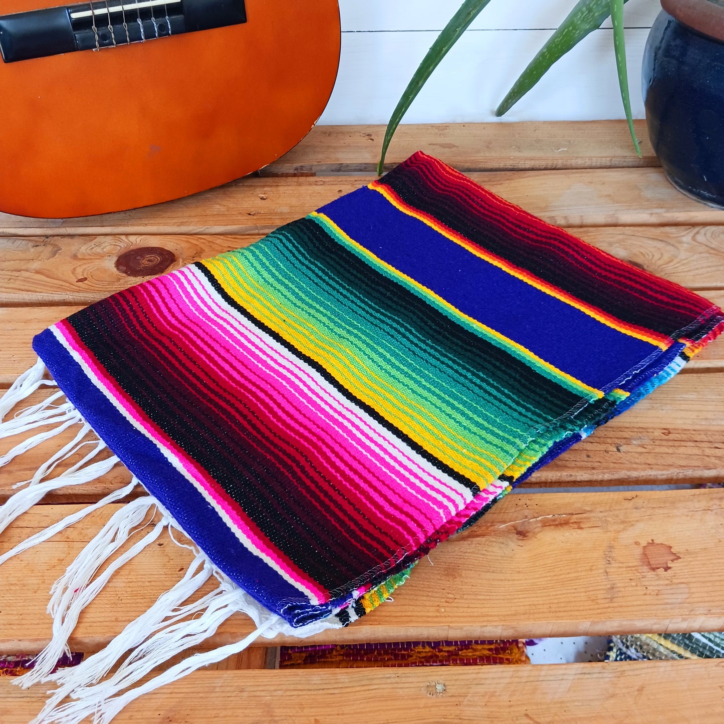 Bring bold colour and cultural charm into your space with our Mexican Serape Vibrant Indigo Blanket. Inspired by traditional Mexican festival textiles, this eye-catching throw features striking pink tones and classic serape stripes that instantly brighten any room.