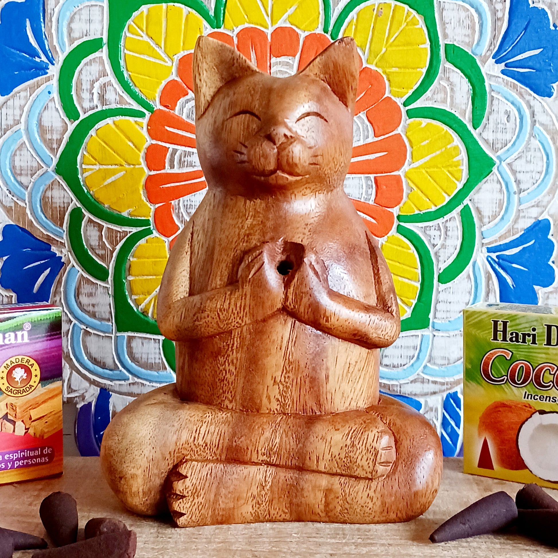 Bring a sense of peace, playfulness, and artistry into your space with this Hand-Carved Wooden Yoga Cat Incense Burner. Each piece is lovingly crafted by skilled Indonesian artisans from sustainably sourced Suar wood, showcasing the perfect blend of mindfulness and feline charm.