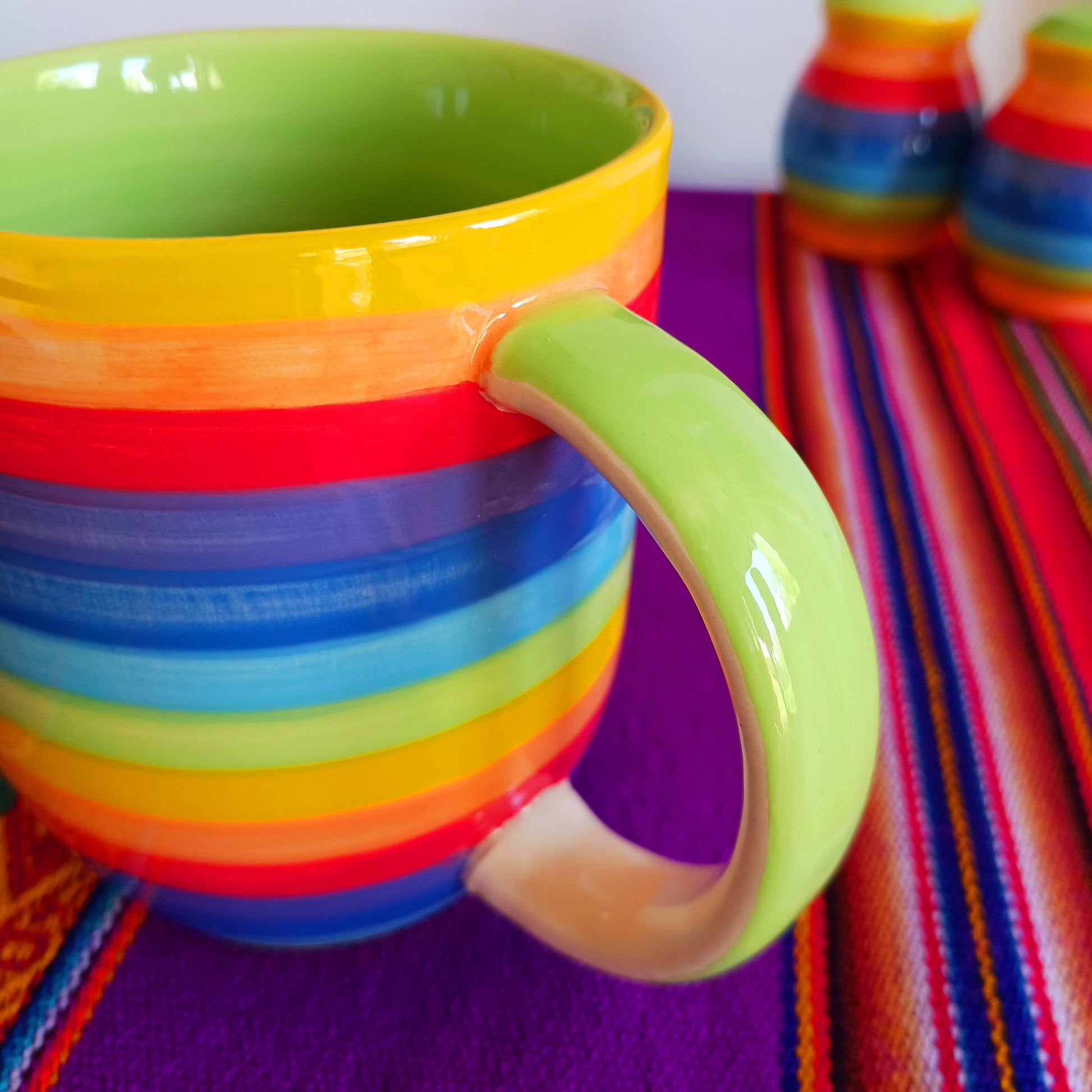 Lovely and colourful rainbow striped mug with a pale green interior.  Perfect for every day use at home. The welcoming design is uplifting and contributes to creating a cosy atmosphere. The traditional profile is finished to a shine glaze, beautifully highlighting the vibrant multi colours.