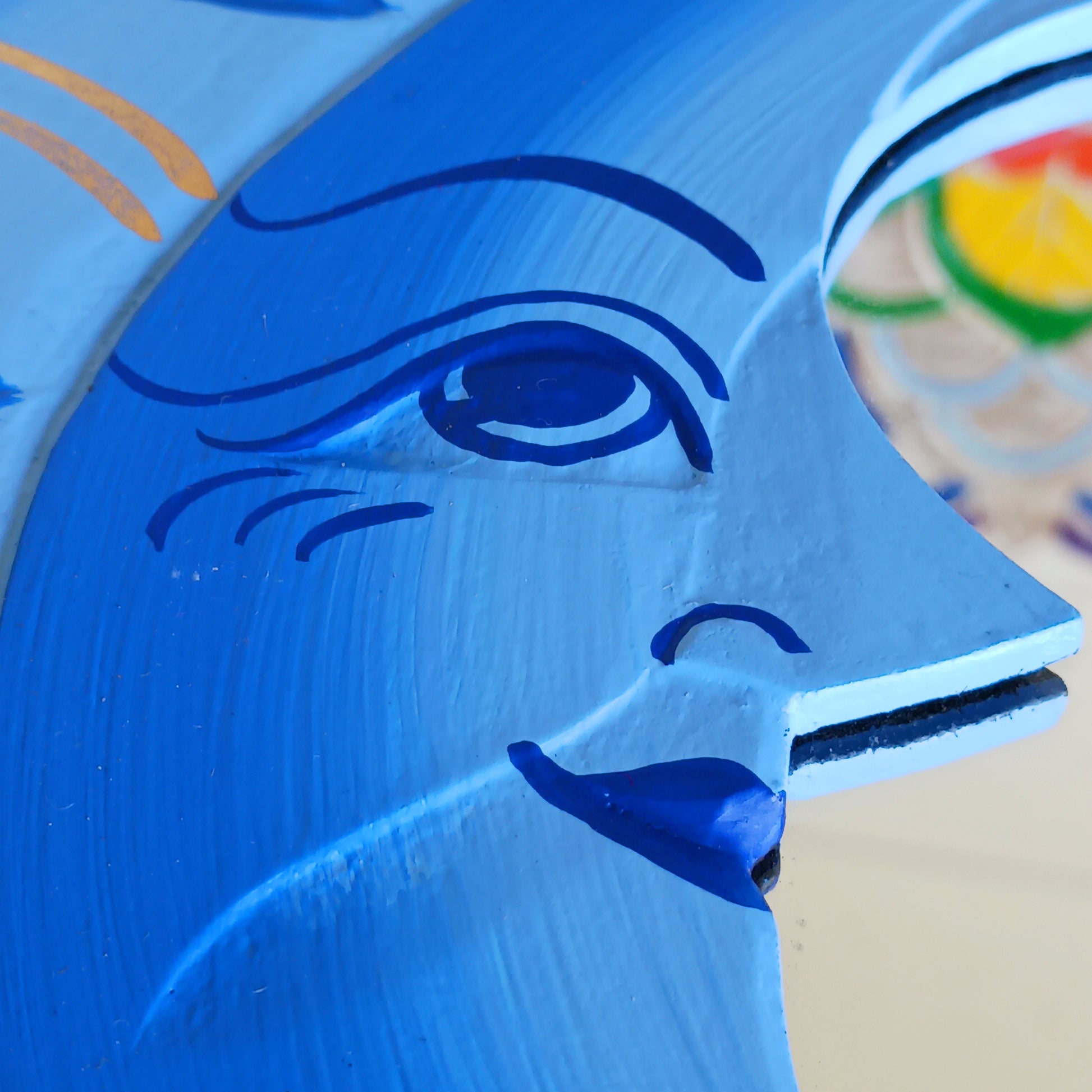 Elevate your home with the mystical charm of our Sun &amp; Moon Mirror. Lovingly handmade by fairtrade artisans, this unique piece features a beautifully painted sun and moon design in vibrant blue tones. Perfect for adding a touch of spirituality, harmony, and positive energy to your living space, this mirror doubles as both a functional piece and captivating art. Ideal for bedrooms, meditation spaces, or as a thoughtful gift for someone special.