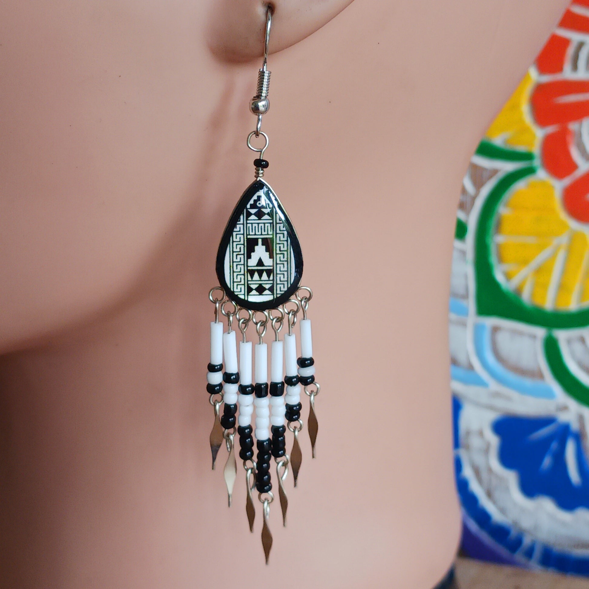 Add a touch of artisan elegance to your jewellery collection with these stunning handmade Peruvian Incan teardrop earrings. Carefully crafted in small family-run workshops in Peru, these eye-catching earrings feature traditional Incan-inspired patterns on the front with a contrasting black reverse for a striking finish.