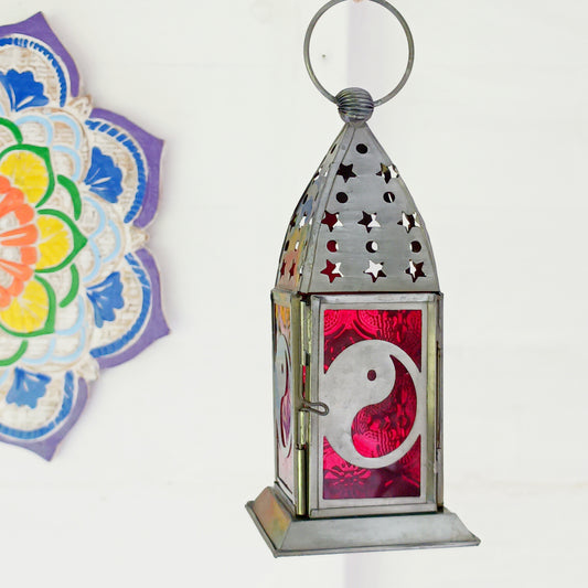 Bring warmth, colour and spiritual harmony to your home with this beautiful Yin Yang Glass Lantern. Designed with vibrant coloured glass panels and a decorative metal cut-out canopy, this lantern creates a calming glow that enhances meditation spaces, yoga rooms and home décor.