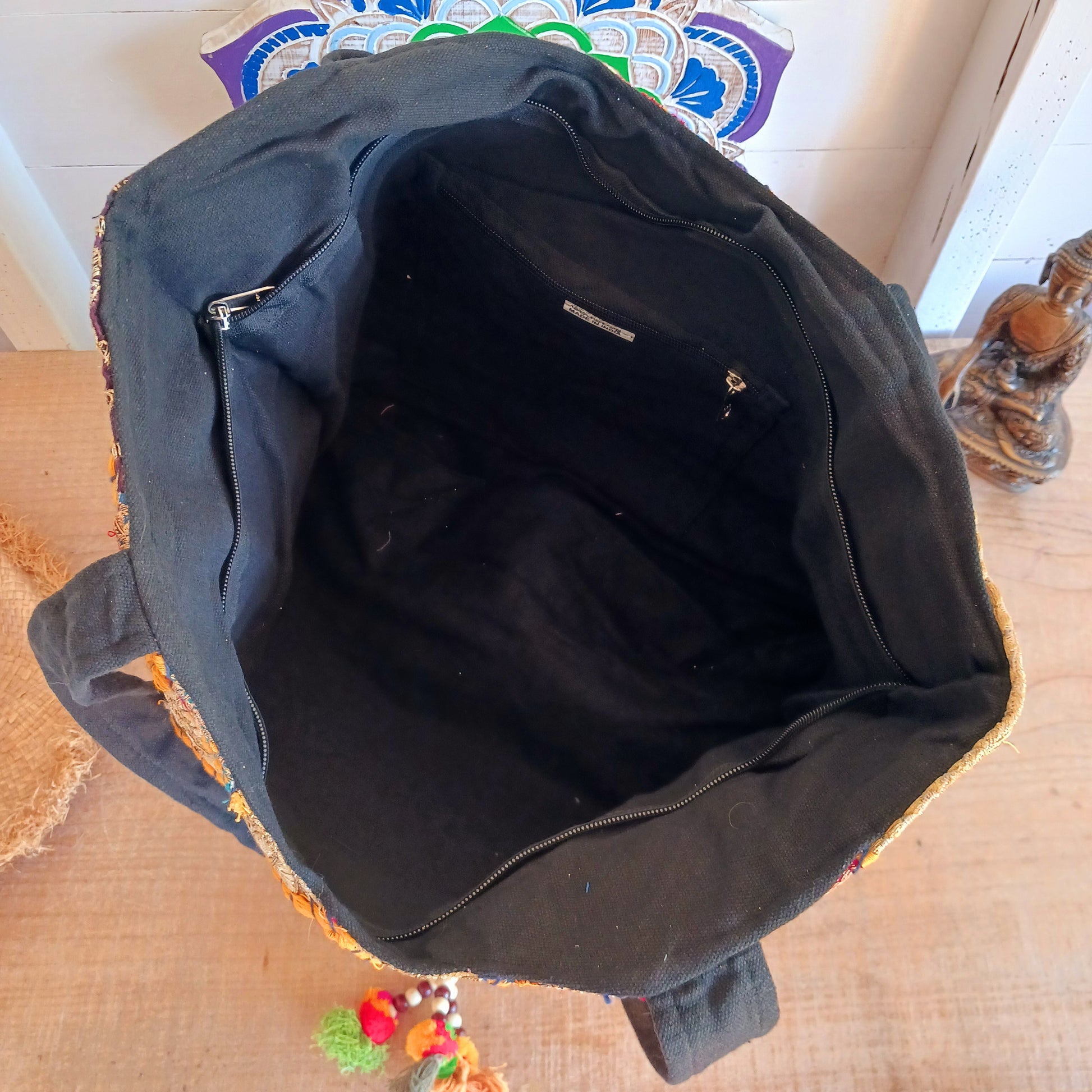This beautiful large Indian tote bag comes with a wide shoulder strap and plenty of space inside for your personal items. In a patchwork style design, this bag is intricately embroidered with a traditional bohemian pattern. The bag comes decorated with beads and pom poms and is fully lined throughout.