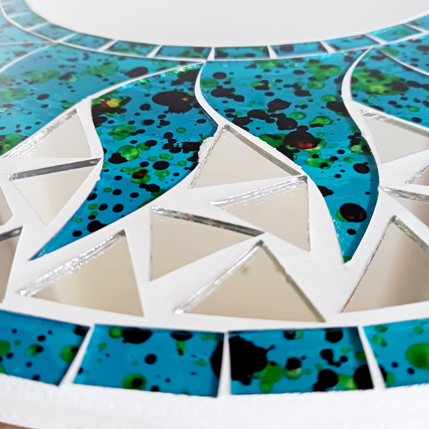 Add warmth, energy, and artistic charm to your home with this beautiful Vibrant Turquoise Mosaic Sun Mirror. Designed with dazzling turquoise mosaic tiles arranged in a radiant sunburst pattern, this captivating wall accent instantly brightens any room. 