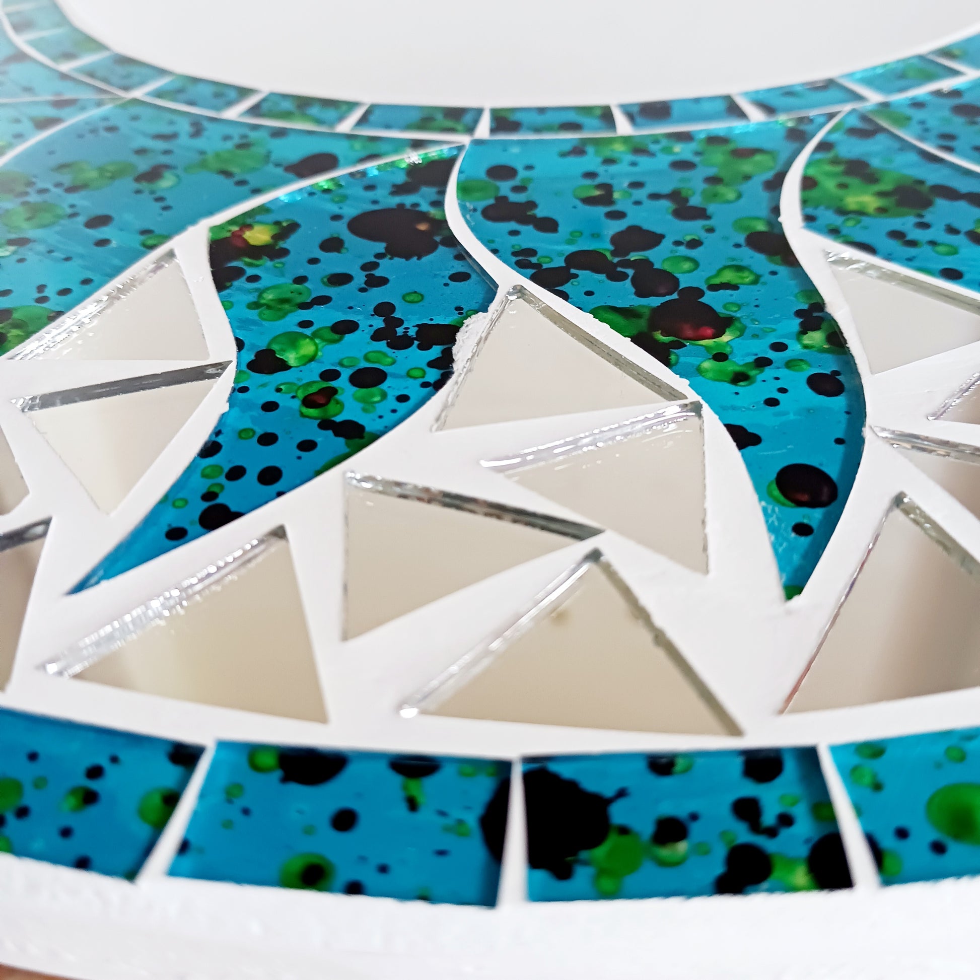 Add warmth, energy, and artistic charm to your home with this beautiful Vibrant Turquoise Mosaic Sun Mirror. Designed with dazzling turquoise mosaic tiles arranged in a radiant sunburst pattern, this captivating wall accent instantly brightens any room. 