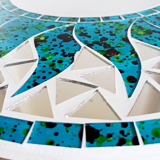 Add warmth, energy, and artistic charm to your home with this beautiful Vibrant Turquoise Mosaic Sun Mirror. Designed with dazzling turquoise mosaic tiles arranged in a radiant sunburst pattern, this captivating wall accent instantly brightens any room. 