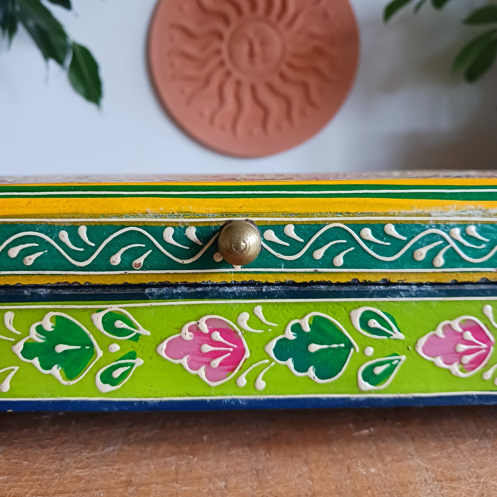 Add charm and colour to your space with this beautifully handmade and hand-painted wooden jewellery box featuring a vibrant lime and floral pattern.