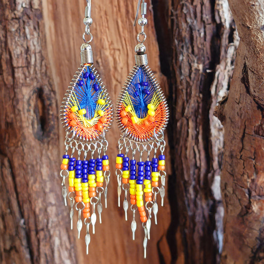Add a splash of colour to your look with these beautiful handmade Peruvian woven teardrop earrings. Inspired by the vibrant colours and patterns of a peacock feather, each earring features intricate woven detailing complemented by coordinating beads and delicate silver-tone embellishments.