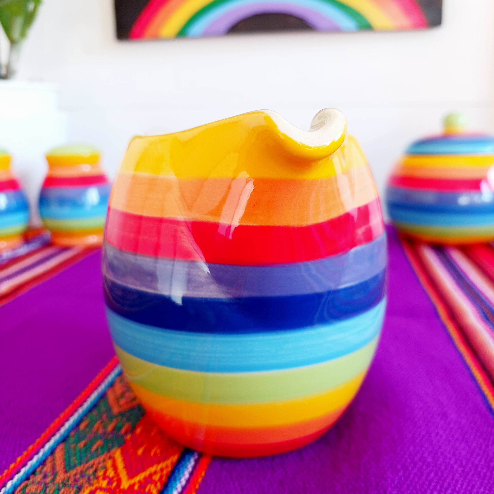 This rainbow stripe ceramic milk jug will brighten up any home. The vibrant stripes are hand painted giving each piece individual character.