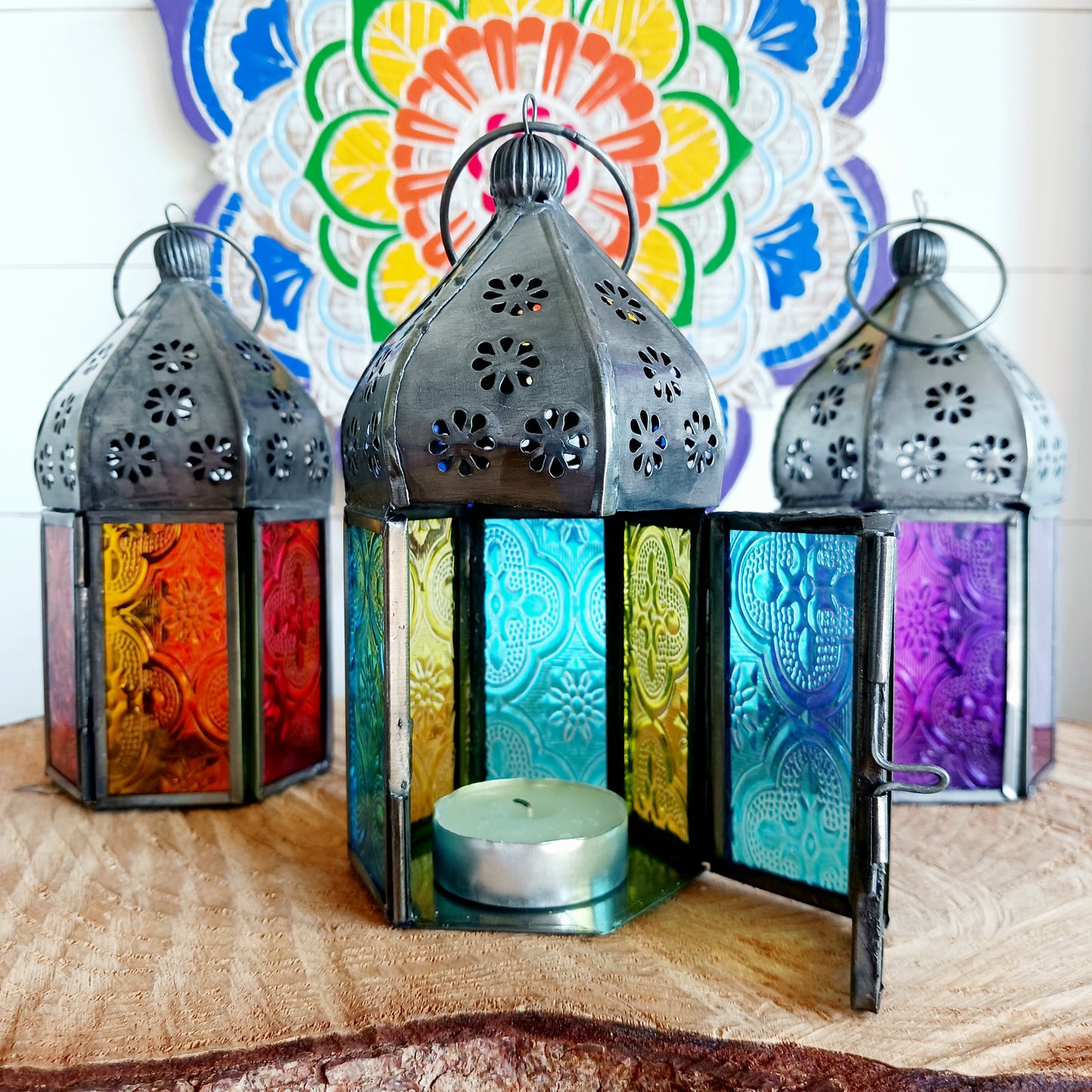 These small glass lanterns come in wonderful colours, featuring an intricate embossed pattern. They have a small hinged door that closes with a sliding catch. The small handle on the top is great for hanging the lanterns around your home. Perfect for adding a touch of warmth to your space.
