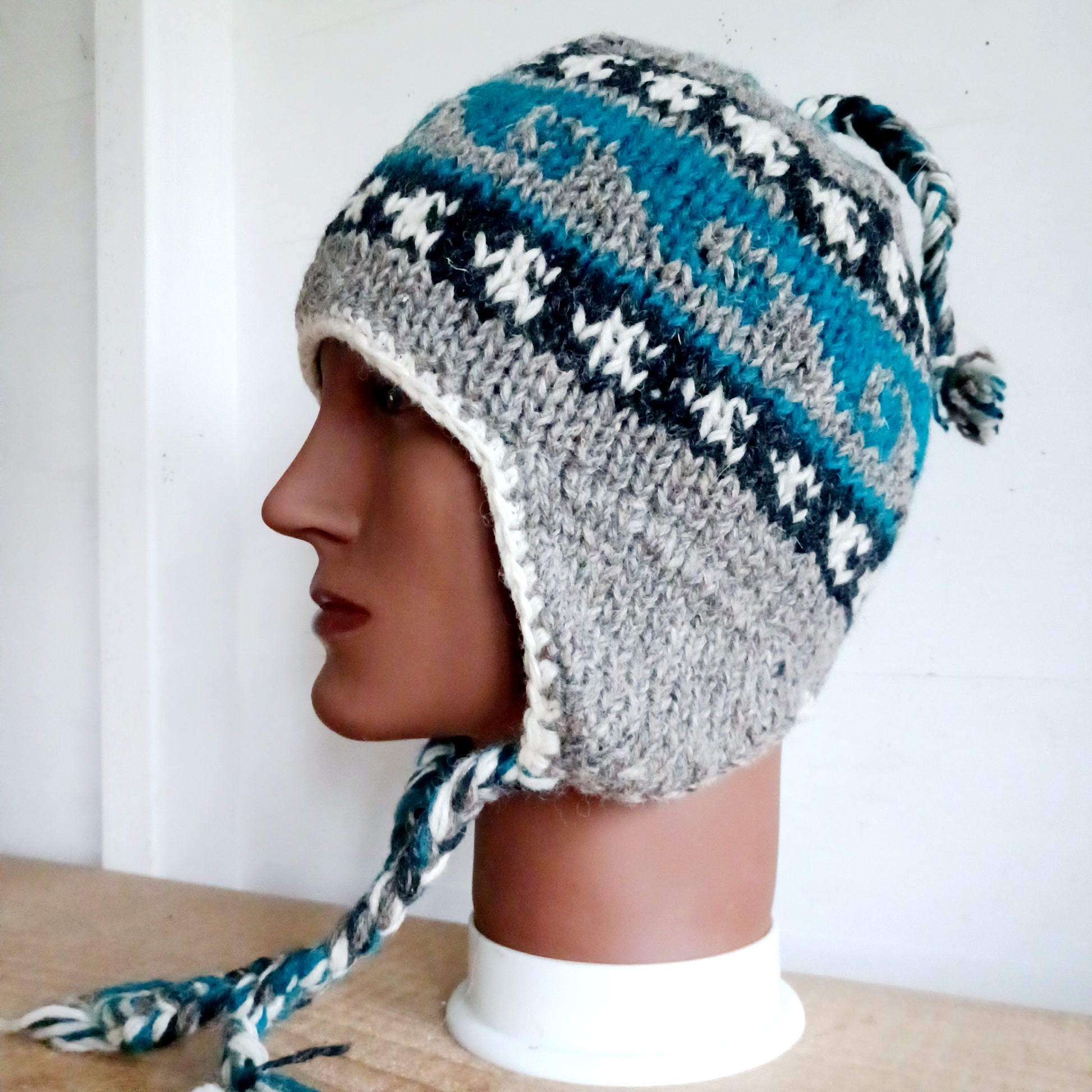 Stay cozy and stylish with our handmade chunky wool earflap hats, crafted in Nepal by skilled women artisans in Kathmandu. Each hat is 100% pure wool and features a soft polar fleece lining for extra warmth and comfort. Perfect for cold winter days, outdoor adventures, or adding a touch of handmade charm to your look.