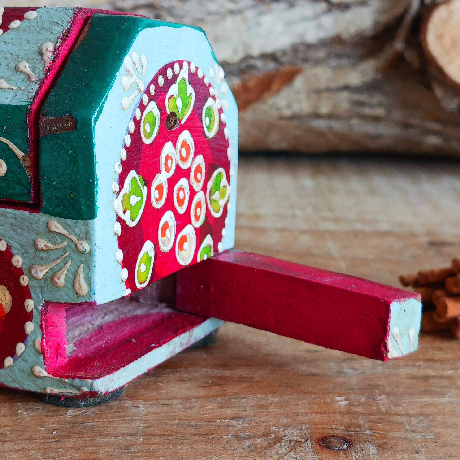 This beautiful turquoise wooden Incense box has been hand painted and has a curved hinged lid. It can accommodate both incense sticks and cones. There is also a place for you to safely store your incense sticks at the bottom on the box.